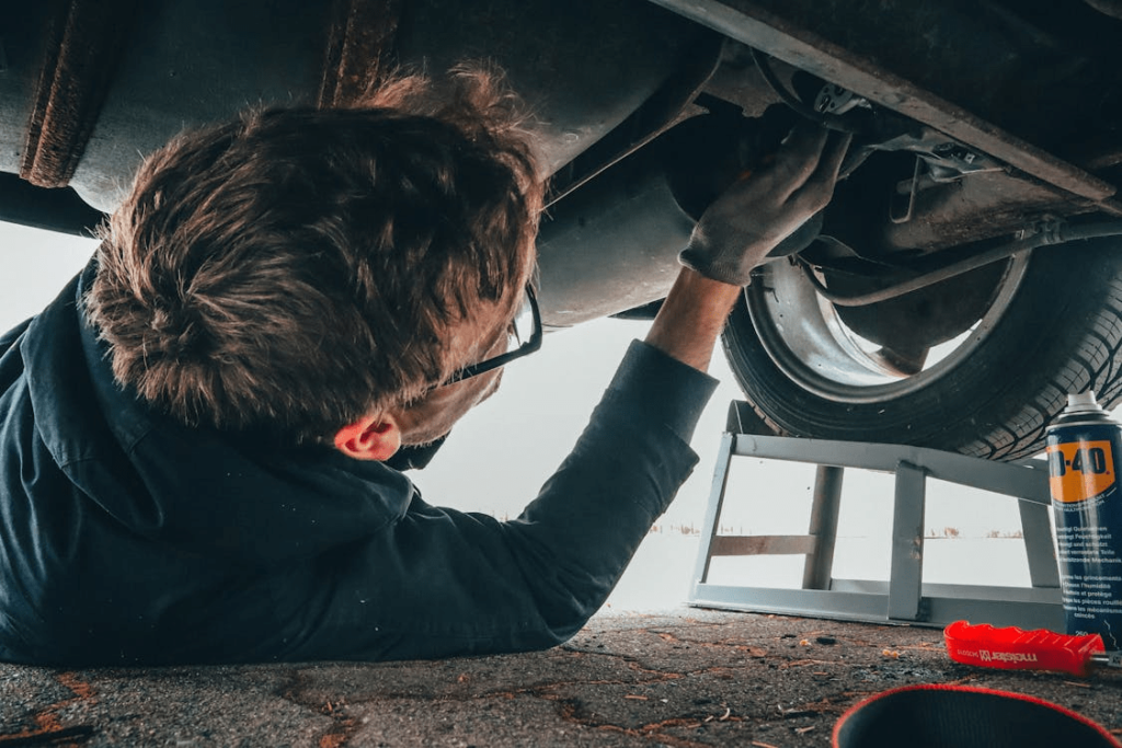 A car mechanic inspecting a car
